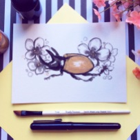 black gold ink painting stag beetle with flowers